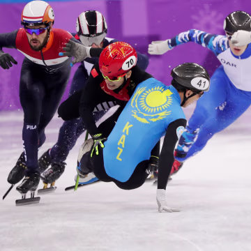 Hongzhi Xu of China and Nurbergen Zhumagaziyev of Kazakhstan collide and crash out during the men's 1,500 meter short track speed skating heat on Feb. 10.