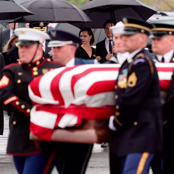 Image: Former President George W. Bush and former First Lady Laura Bush watch as the casket of former President George H.W. Bush is carried to a Union Pacific train following his funeral in Spring, Texas, on Dec. 6, 2018.