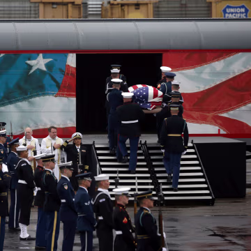 Image: A joint services military honor guard brings former President George H.W. Bush's casket onto a Union Pacific train.