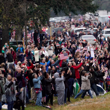 Image: People pay their respects as the train carrying former President George H.W. Bush travels from Spring to College Station, Texas.