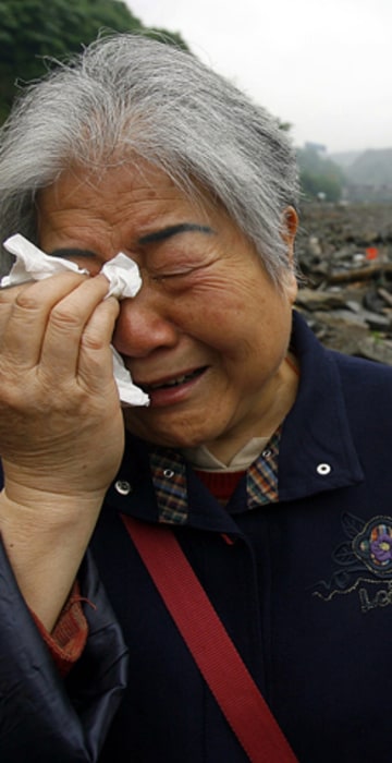 Image: An elderly Chinese woman cries