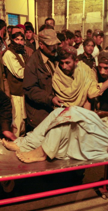 Image: A man, injured from the site of a bomb explosion, is brought to a hospital for treatment in Quetta