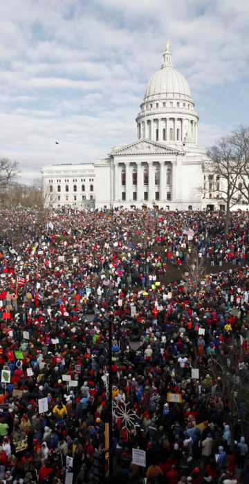 Image: Massive crowds gather to see 14 democratic senators that left state to protest bill proposed by Gov. Walker as crowds continued to protest at the Wisconsin State Capitol in Madison