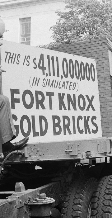 Rep. George Hansen, R-Idaho, left, and other members of Congress gather around a truck loaded with 44,300 simulated gold bricks on Wednesday, April 25, 1979 in Washington to indicate their strong opposition to the estimated $4.1 billion dollars it will cost the U.S. taxpayers to give away the Panama Canal. From left are Hansen, Reps. Ron Paul, Texas; Floyd Spence, R-S.C.; William Dannemeyer, R-Calif.; and Phil Gramm, D-Texas. (AP Photo/Daugherty)