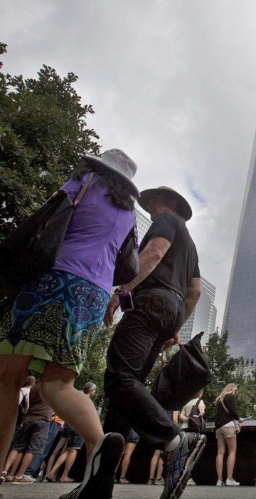 Image: People line up to look into the South Pool under the One World Trade Center at the National September 11 Memorial in New York