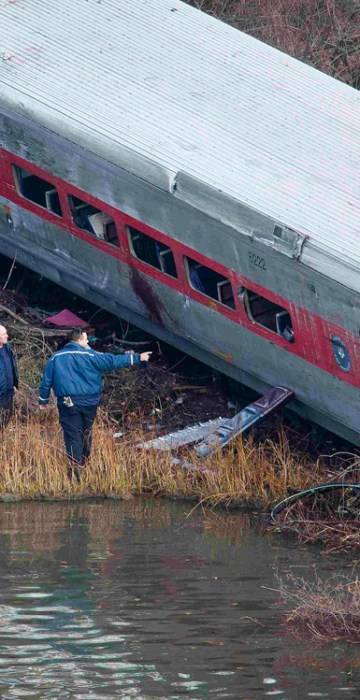 Image: Emergency workers examine the site of a Metro-North train derailment in the Bronx borough of New York
