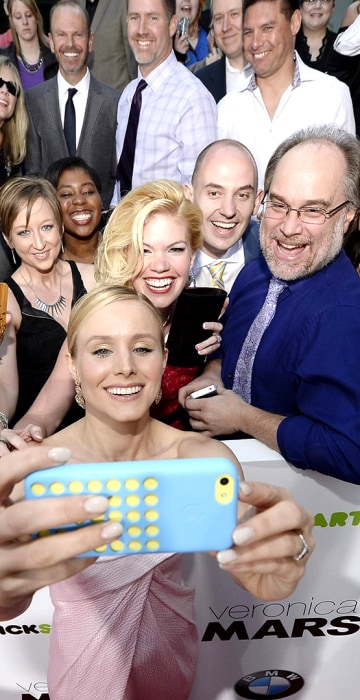 Image: Cast member Kristen Bell takes a \"selfie\" with the Kickstarter crowd that helped fund \"Veronica Mars\" at the premiere of the film at the TCL Chinese Theater in Hollywood