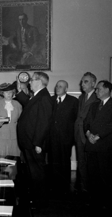 Harry S. Truman, left, is sworn in as President of the United States by Chief Justice Harlan Stone, in the executive offices of the White House, Washington, DC, April 12, 1945, following the death of Franklin D. Roosevelt at Warm Springs.  Mrs. Truman is at the center.  Attorney General Francis Biddle is just behind Truman, and between the new President and Mrs. Truman is Secretary of State Edward R. Stettinius, Jr.  (AP Photo/stf)