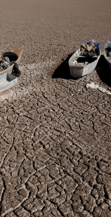 Image: Boats of fishermen are seen on the dried Poopo lakebed in the Oruro Department, south of La Paz