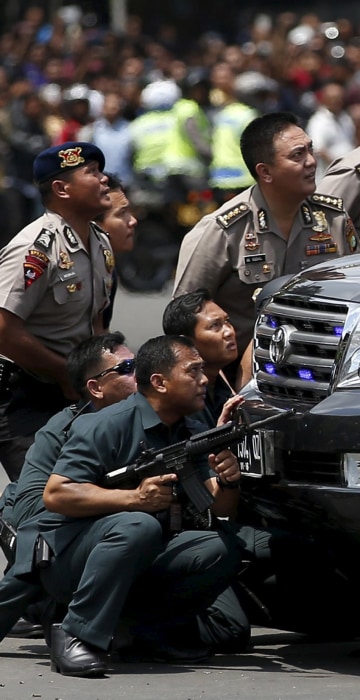 Image: Police officers react near the site of the blast