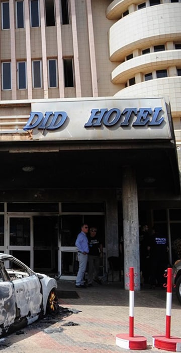 Image: Damaged cars parked out the hotel