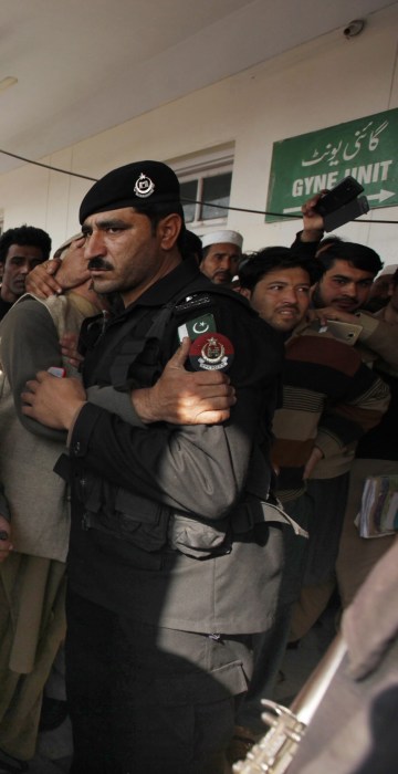 Image: People react outside the hospital as victims, of the gun attack on university arrive