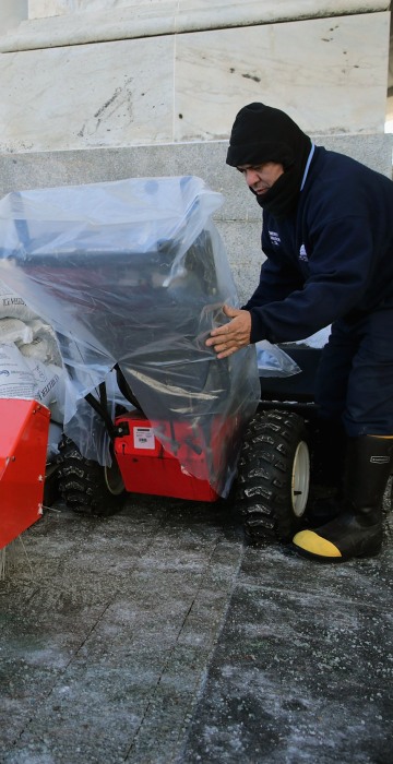 Image: A Stone covers gas powered snow sweepers in plastic bags