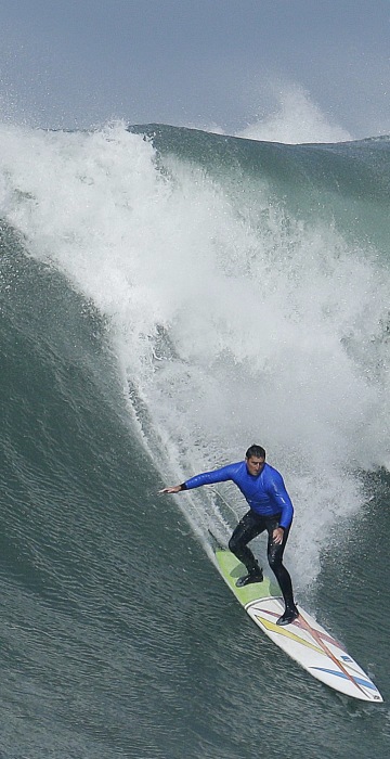 Image: Ben Wilkinson, left, surfs beside Greg Long who wipes out on a giant wave