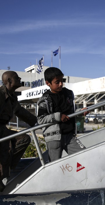 Image: Children play outside Athens' old airport