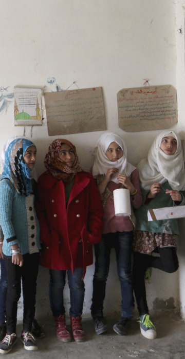 Image: Students hold geometrical forms to decorate the Freedom School, in the town of al-Tamanah, in the southern countryside of Idlib
