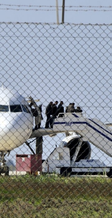 Image: Passengers evacuate a hijacked EgyptAir Airbus 320 plane at Larnaca airport