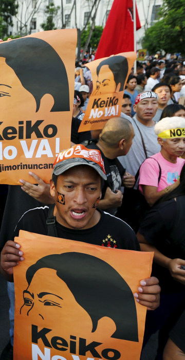 Image: Protesters holding signs attend a march against Peruvian presidential candidate Keiko Fujimori in downtown Lima