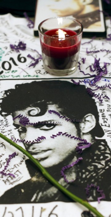 Image: Flowers and candles are placed at a makeshift memorial for the music legend in Harlem, New York