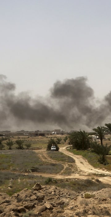 Image: Smoke rises from Islamic State group positions at the front line during fight against Islamic State outside Fallujah
