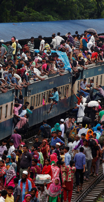 Image: People climb to board an overcrowded passenger train as they travel home to celebrate Eid al-Fitr festival, which marks the end of the Muslim holy fasting month of Ramadan, at a railway station in Dhaka
