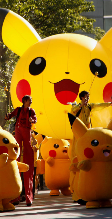 Image: Performers wearing Pokemon's character Pikachu take part in a parade in Yokohama