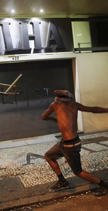Image: A demonstrator attacks the Folha de S. Paulo newspaper office during a protest against Brazil's new President Michel Temer after Brazil's Senate removed former President Dilma Rousseff in Sao Paulo
