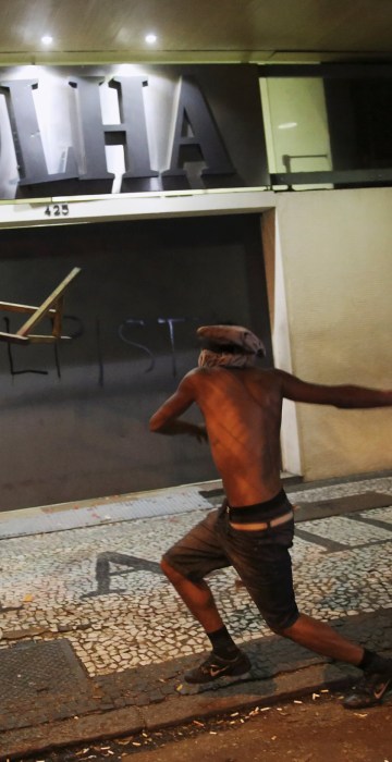 Image: A demonstrator attacks the Folha de S. Paulo newspaper office during a protest against Brazil's new President Michel Temer after Brazil's Senate removed former President Dilma Rousseff in Sao Paulo
