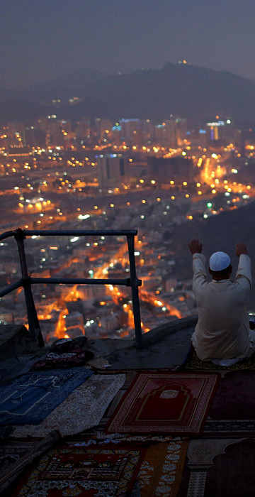 Image: A pilgrim prays at Mount Al-Noor ahead of the annual haj pilgrimage in the holy city of Mecca
