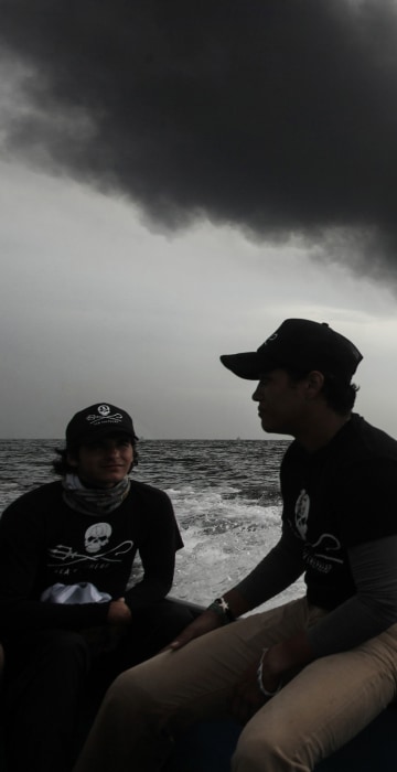 Image: Members of the marine wildlife conservation organization Sea Shepherd monitor the fuel tanker Burgos as it burns