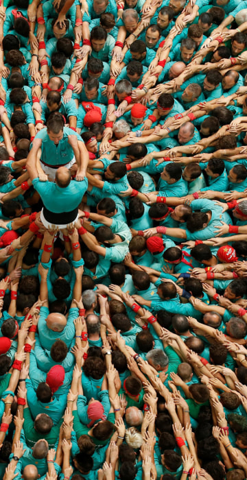 Image: Castellers de Vilafranca start to form a human tower called \"castell\" during a biannual competition in Tarragona city