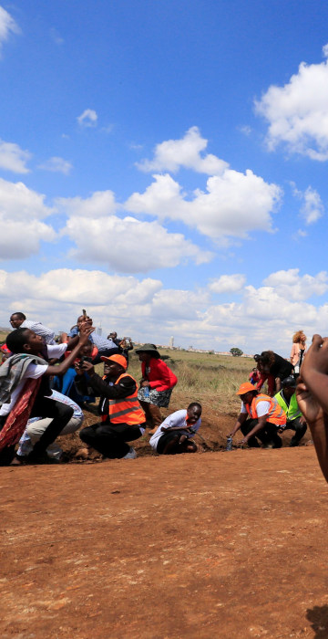 Image: Spectators react as a plane flies over them during the Vintage Air Rally at the Nairobi national park in Kenya's capital Nairobi