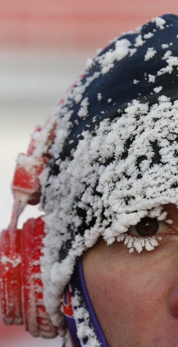 Image: A runner with his face covered with hoarfrost competes during the traditional half Marathon amateur competition marking the Orthodox Christmas Day festivities.