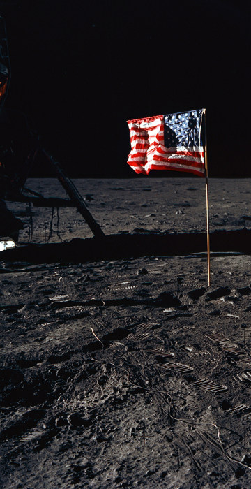 Image: Astronaut Edwin E. Aldrin Jr., lunar module pilot of the first lunar landing mission, poses for a photograph beside the deployed United States flag