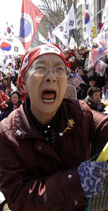 Image: A supporter of the South Korean president cries during a rally opposing her impeachment.