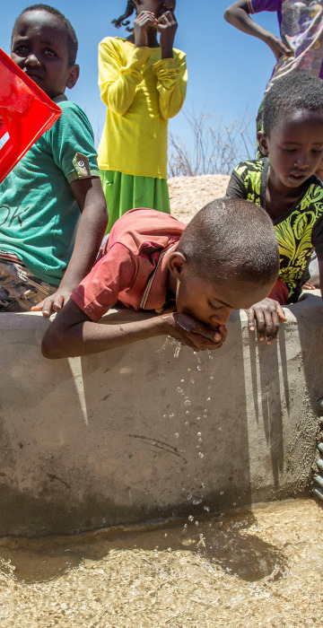 Image: Children drink water delivered by a truck in the drought-stricken Baligubadle village in this handout provided by The International Federation of Red Cross and Red Crescent Societies on March 15.