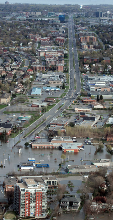 Image: An overhead view showing St Jean Blvd., in the flooded residential neighbourhood in Pierrefonds, Quebec, Canada