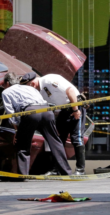 Image: Police investigate the vehicle that drove onto sidewalk and struck pedestrians in Times Square in New York