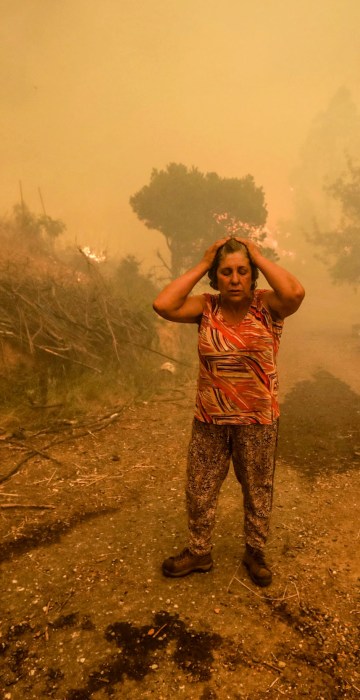 Image: A woman reacts in Pampilhosa da Serra, central Portugal on June 18.