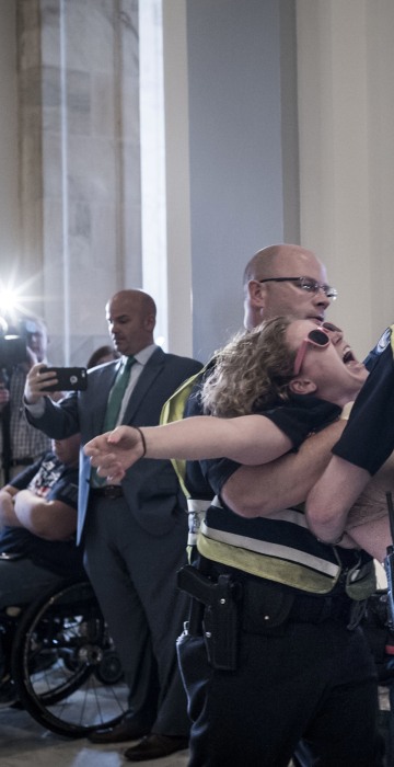 Image: U.S. Capitol Police remove a protester from the Russell office building on Capitol Hill