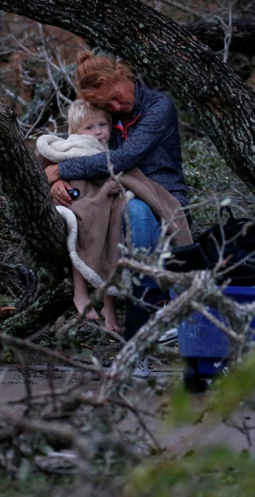 Image: Lisa Rehr holds her four-year old son Maximus, after they lost their home to Hurricane Harvey