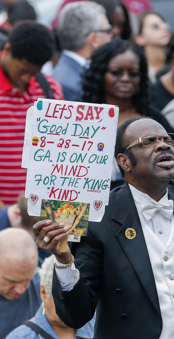 Image: A man reacts during the unveiling ceremony of a statue of slain civil rights leader Martin Luther King Jr.