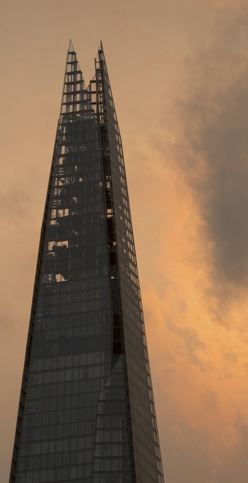 Image: A plane flies past the Shard in central London, as the sky takes on an unusual orange colour
