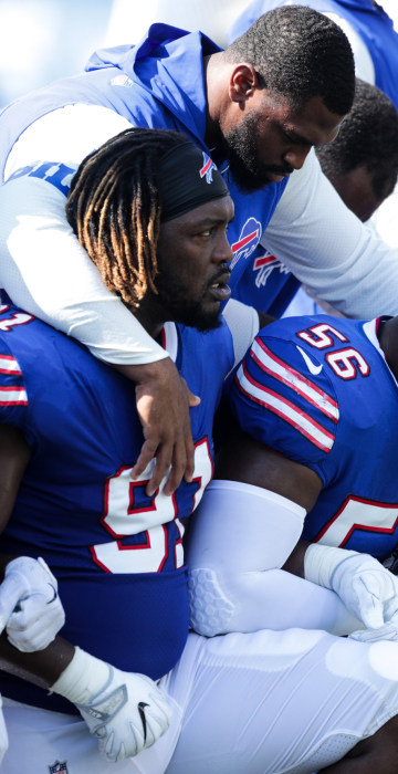 Image: Buffalo Bills players kneel during the American National anthem