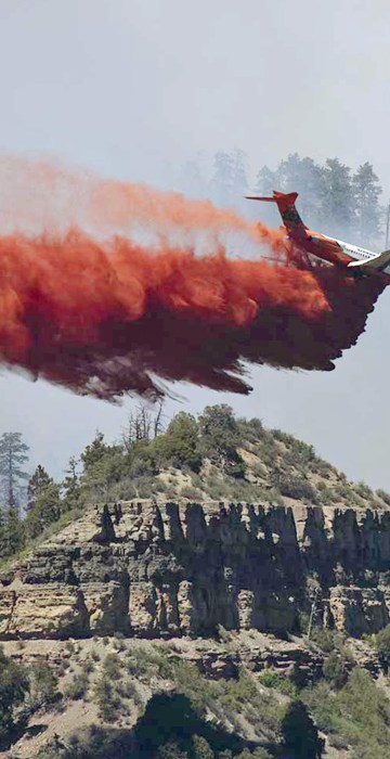 Image: An aircraft makes a fire retardant drop on a wildfire in the mountains and forests near Durango, Colorado
