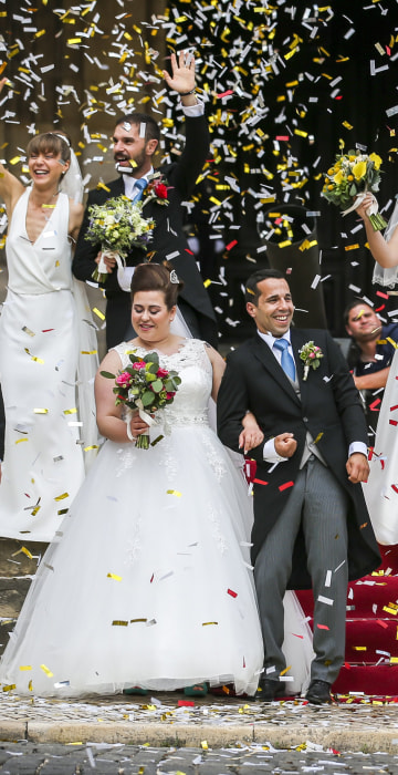Image: Newlywed couples pose after getting married at the Cathedral of Lisbon in Portugal