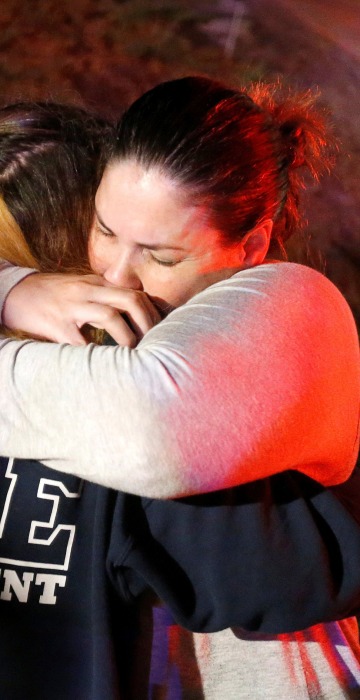 People hugged each other outside of the Borderline Bar in Thousand Oaks