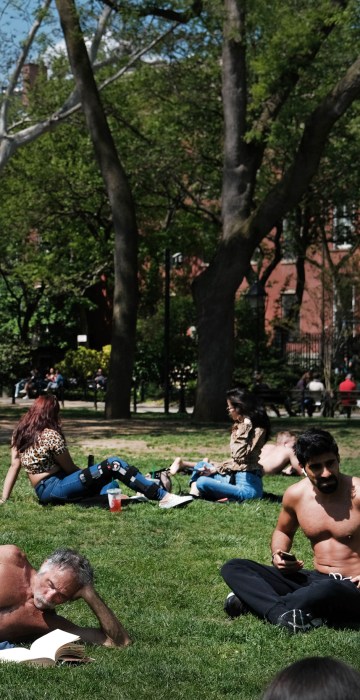 Image: Sunbathers relax in Washington Square Park in New York on May 8, 2019.