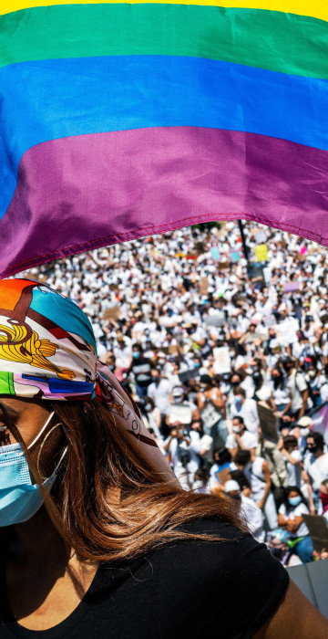 Image: Tiffany Munroe waves a Pride flag during a rally to call attention to violence against transgender people of color in Brooklyn on Sunday, June 14, 2020. (Demetrius Freeman/The New York Times)