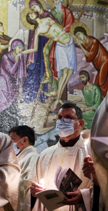 Fransiscan friars pray during mass on Easter Sunday at the Church of the Holy Sepulchre in Jerusalem.